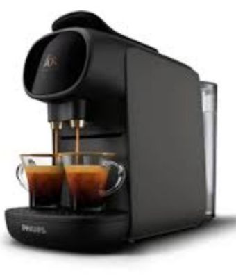 a close up of a coffee machine with two cups of coffee