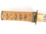 a close up of a knife on a white surface