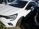 a white car parked in a parking lot with other cars