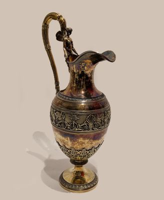 an image of a gold and silver vase on a white surface