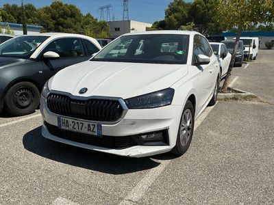 a white car parked in a parking lot next to other cars