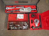 a red tool box with tools in it on the ground