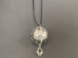 a silver ball with a silver anchor and a silver anchor on a black cord