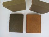 four books are lined up on a white surface, one is brown and the other is brown