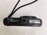 a black camera with a black strap attached to it