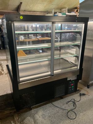 a refrigerated display case in the middle of a room