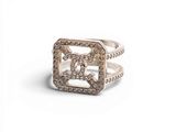 a close up of a ring with diamonds on a white background