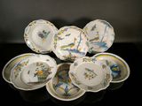 many plates and bowls that are sitting on a table