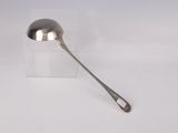 silver spoon with a handle on a white surface