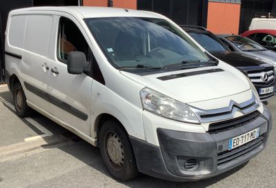 une camionnette blanche garée dans un parking