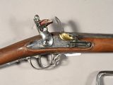 a gun that is sitting on a table next to a chair