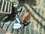 a pair of scissors laying on the ground next to a sign