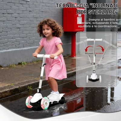 a little girl that is riding a scooter on the street