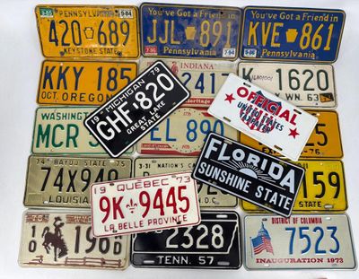 many different license plates on display on the table