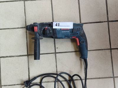 a drill that is laying on the floor next to a cord