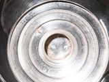 a person holding a silver bowl in their hands