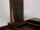 a wooden dresser with a mirror on top of it