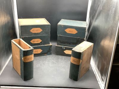 three boxes that are sitting inside of a glass case