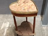 a small table with a heart shaped top on it