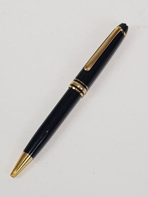 the pen is black and gold with a gold trim