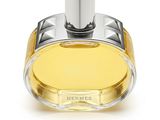 un flacon de parfum posé sur une surface blanche