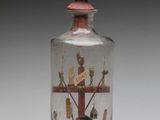 a glass bottle with a picture inside of it