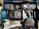 a cordless drill and two batteries in a blue box