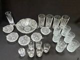 a lot of glassware on a table with a black background