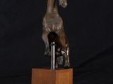 bronze sculpture of a horse on a wooden base
