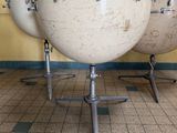 three drums that are sitting in a row on a tiled floor