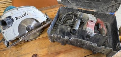 two circular saws in a box on a table