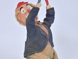 a toy figurine of a man holding a pair of scissors
