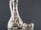 a vase and a cup sitting next to each other on a table