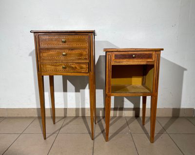 two wooden tables with drawers on them in a room
