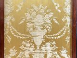 a picture of a chair that has a gold and white wallpaper on it
