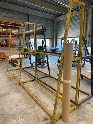 a large metal rack with a roll of paper on it