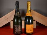 two bottles of champagne sitting next to each other on a table