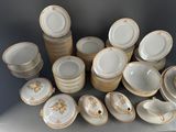 a lot of plates and bowls that are sitting on a table