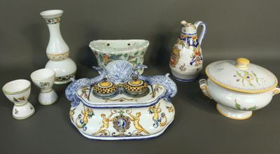 many different pieces of porcelain on display on the table