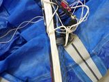 a pair of skis and a pair of scissors on a blue tarp