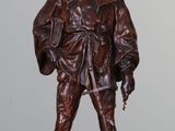 bronze statue of a man in a hat and uniform