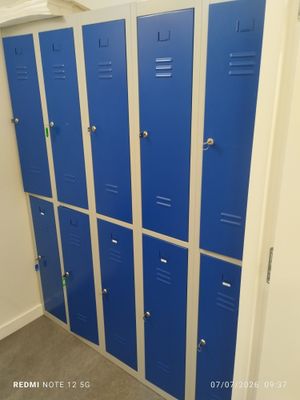 several blue lockers are lined up in a row in a room