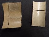 two pieces of brown paper sitting on top of a black table