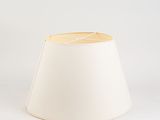 a white lamp shade sitting on top of a white table