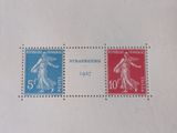 two stamps on a piece of paper with a picture of a woman and a man