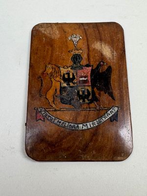 a wooden plaque with a picture of a coat of arms on it