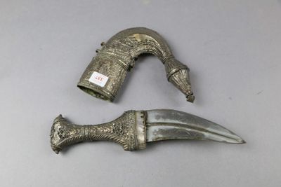 two pieces of silver metal with a knife on top of it