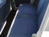 a seat in the back of a car with a blue seat cover