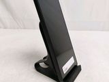 a cell phone that is on a stand on a table