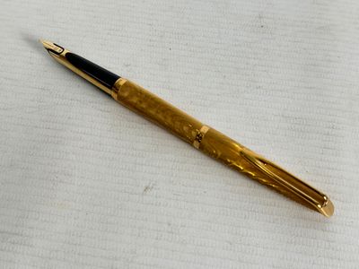 a pen that is laying on top of a piece of paper